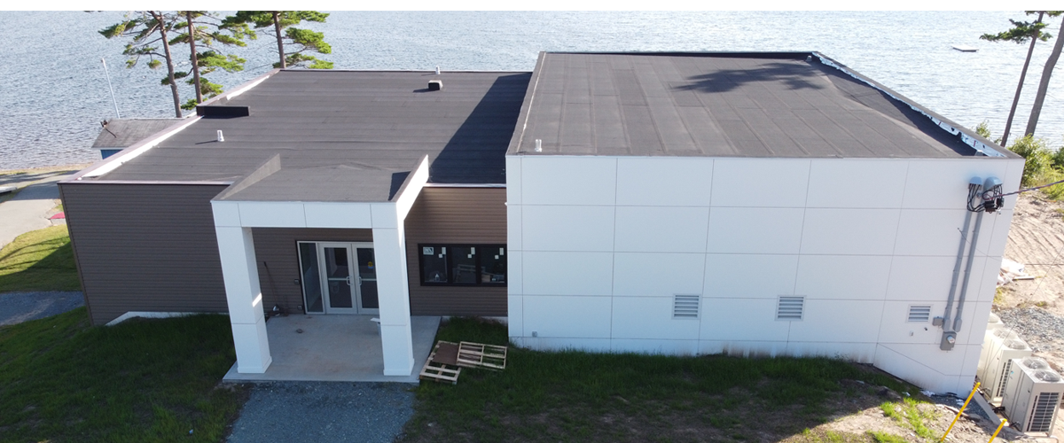 Aerial view of a modern building next to a lake.