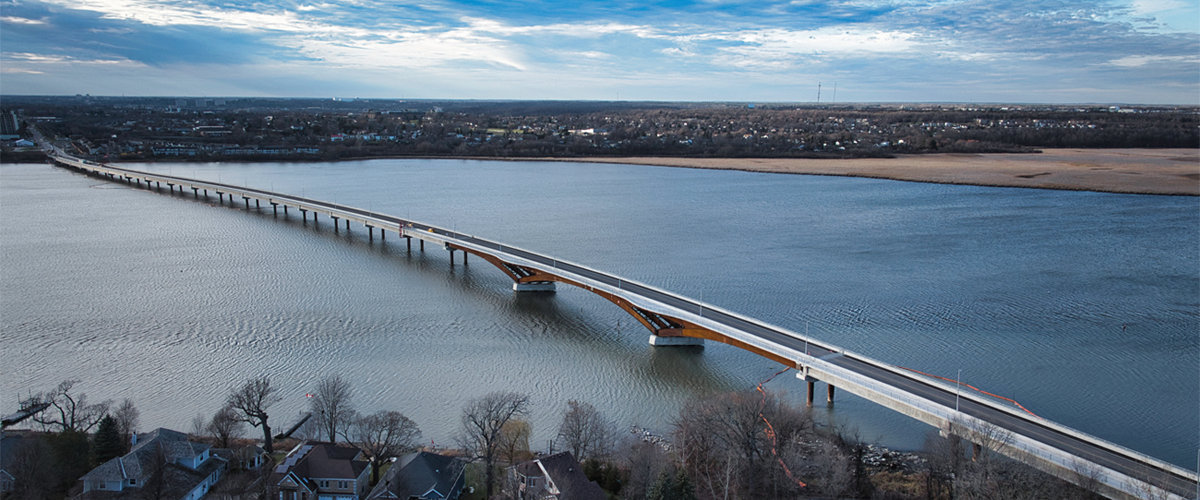 A bridge over a river with rocky banks.